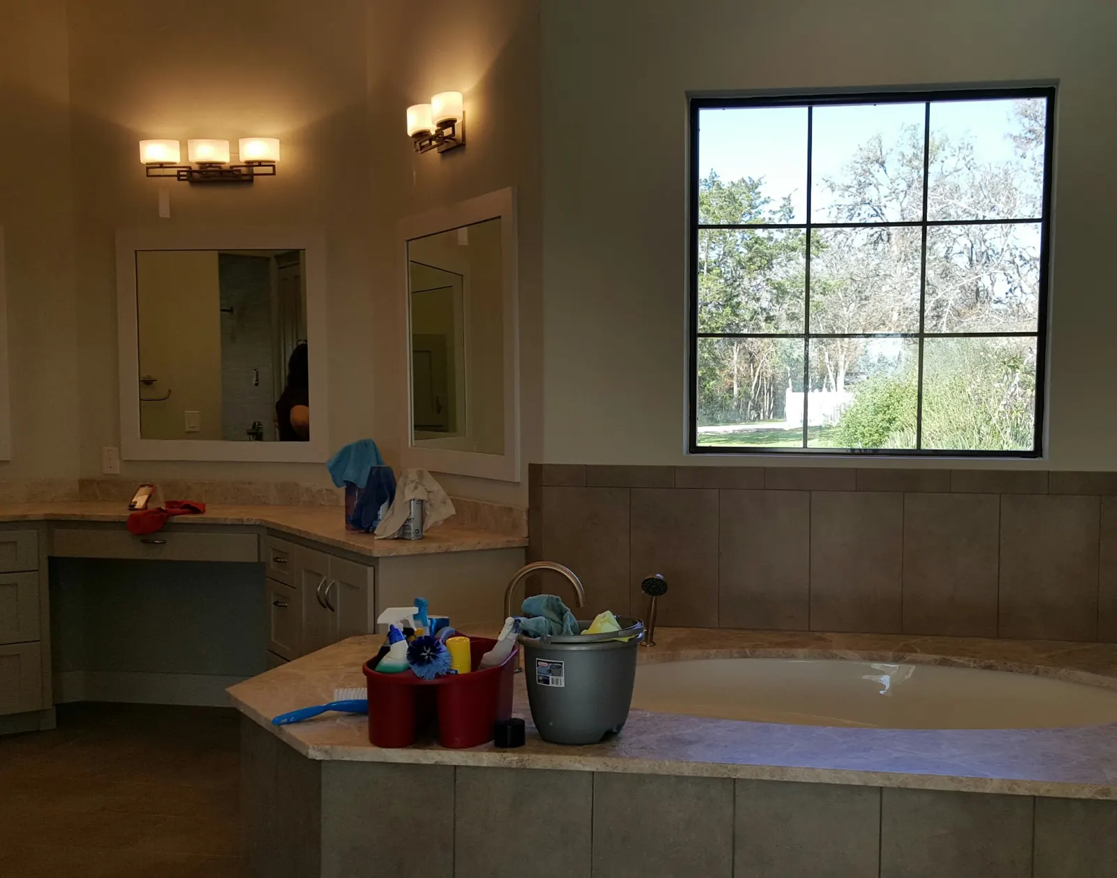 Bathroom mid-clean with Premier Pro supplies on the tub surround